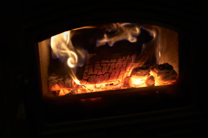Narrowboat multi-fuel stove burning wood