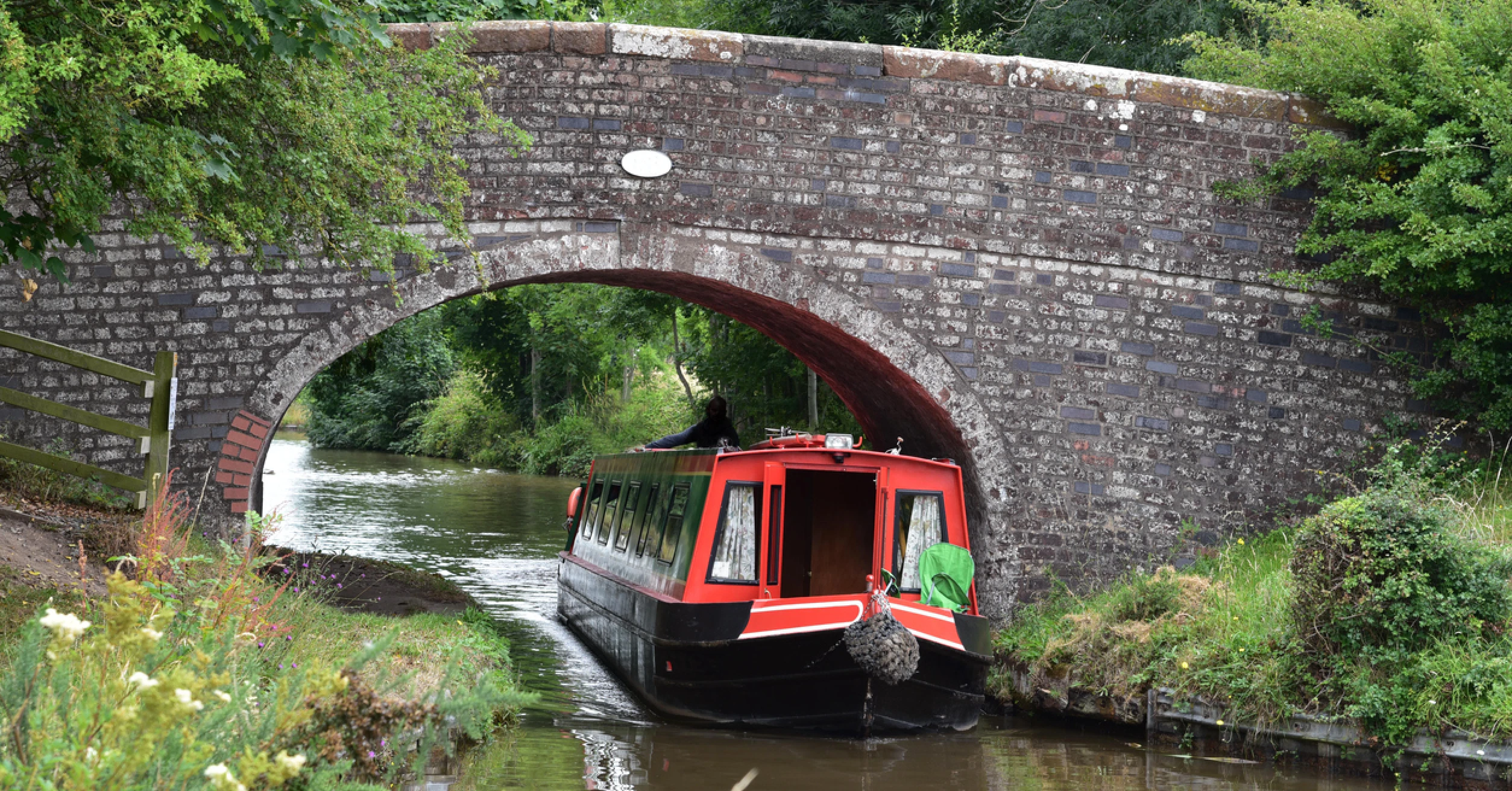 A narrowboat passing though a bridge hole on the Llangollen Canal